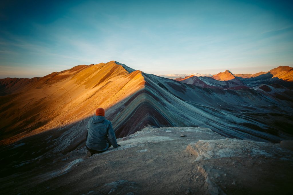 Tourist at the top of Rainbow Mountain
