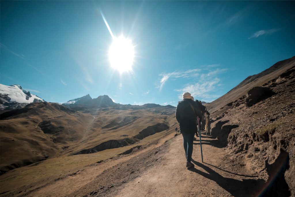 Trekker walking along the Andean path to Rainbow Mountain on the Ausangate Trek