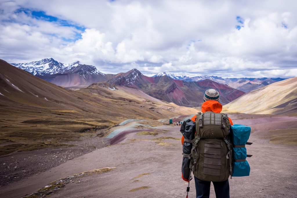 Hiker along the trail to Rainbow Mountain